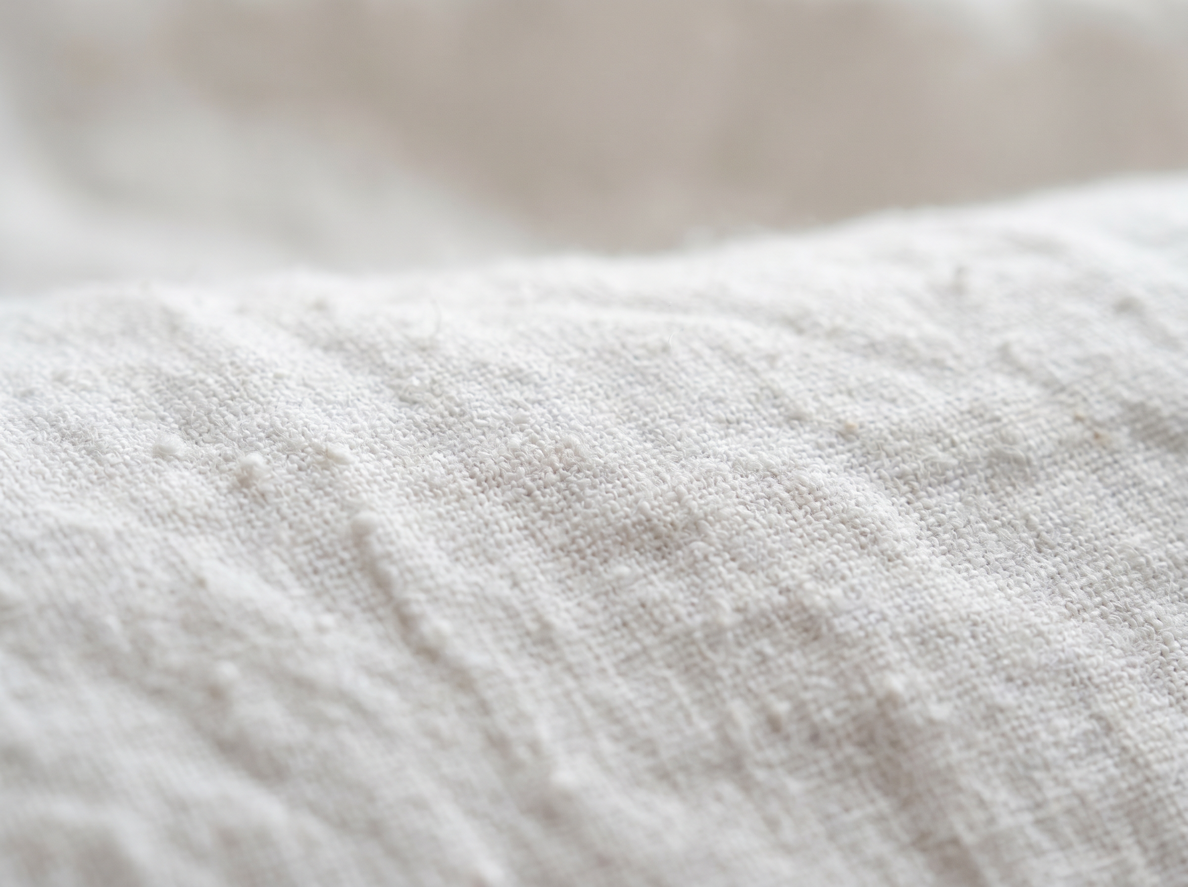 Close-up of textured white linen sheets