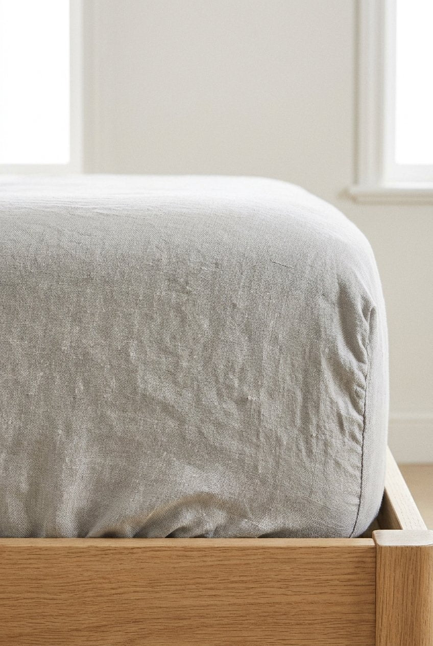 Premium linen fitted sheet in natural beige — texture close-up