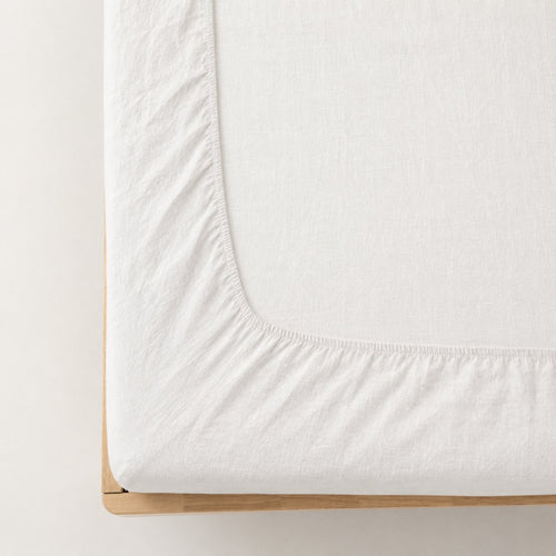 Premium linen fitted sheet in white — corner detail showing elastic hem