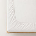 Premium linen fitted sheet in white — corner detail showing elastic hem