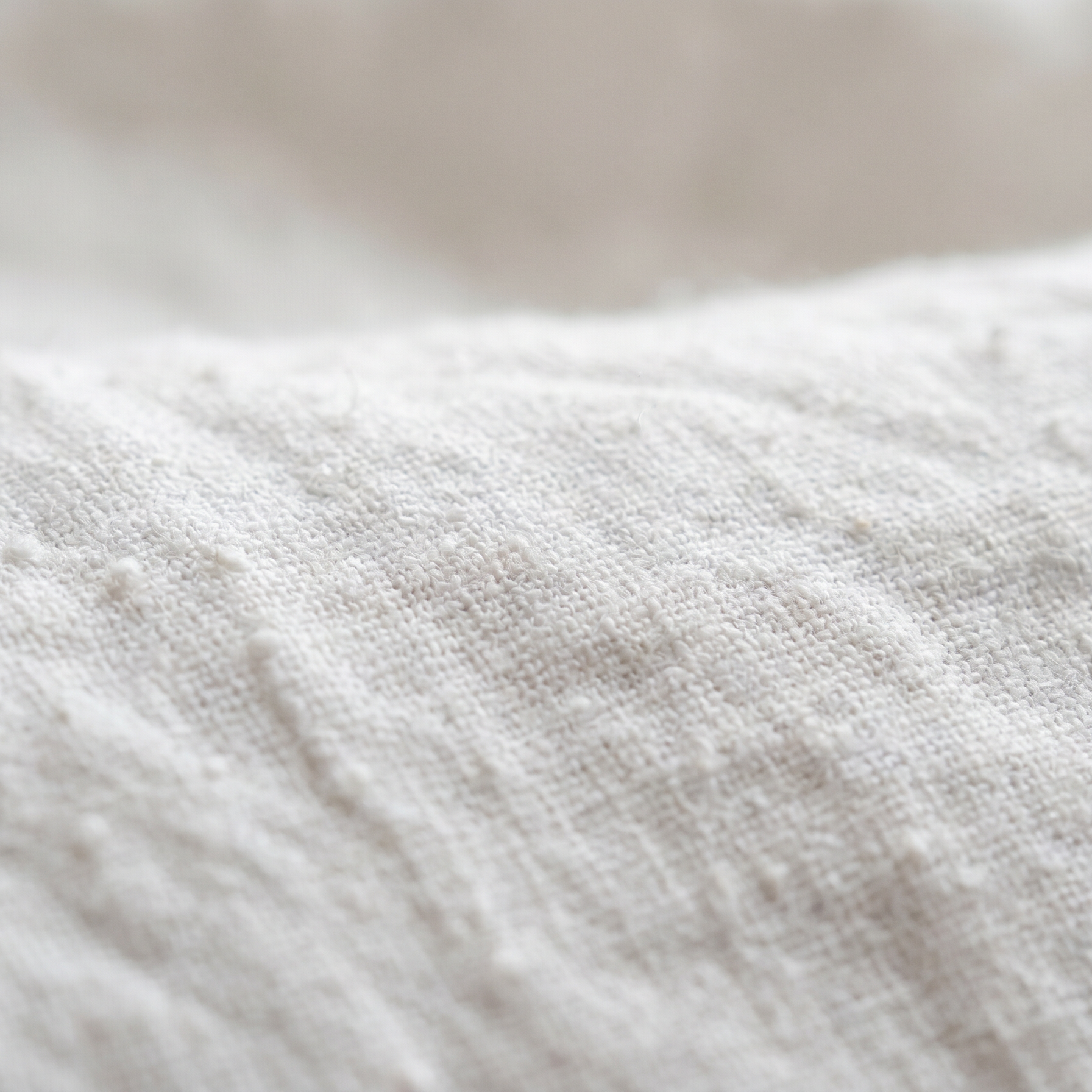 Close-up of textured white linen sheets